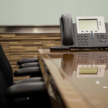 nextiva enterprise voip service office phone on table office black chairs